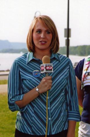Image of Sara holding a TV station microphone